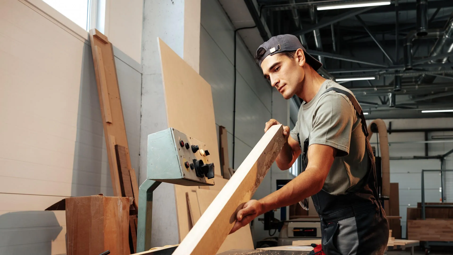 young-carpenter-working-on-woodworking-machines-in-2023-11-27-05-20-53-utc(1)
